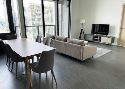 Modern living room with dining area and city view