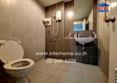 Modern bathroom with tiled walls and fixtures