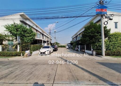 Street view of residential area with houses and cars