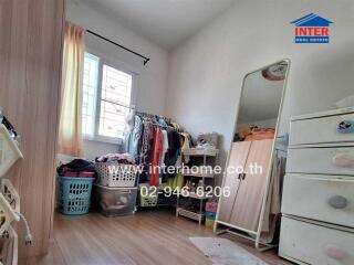 Bedroom with wardrobe, mirror, and storage