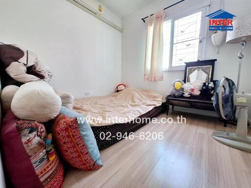 Cozy bedroom with single bed and stuffed animals