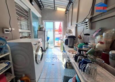 Laundry room with washer and various household items