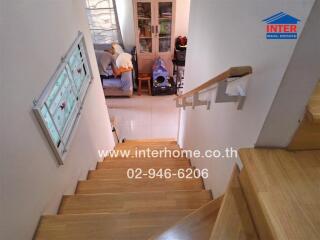 Indoor staircase with wooden steps leading to the lower floor