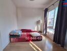 Minimalist bedroom with futon and natural light