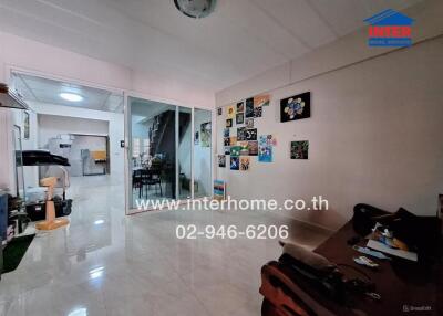 Living room with glass partition, artistic wall decorations, and couch