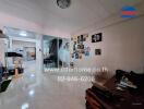 Living room with glass partition, artistic wall decorations, and couch