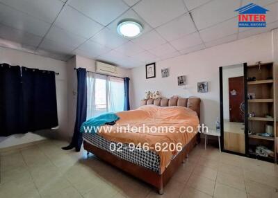 Spacious bedroom with large window and double bed