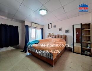 Spacious bedroom with large window and double bed