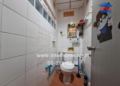 Small bathroom with toilet and wall decorations