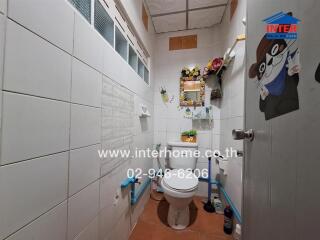 Small bathroom with toilet and wall decorations