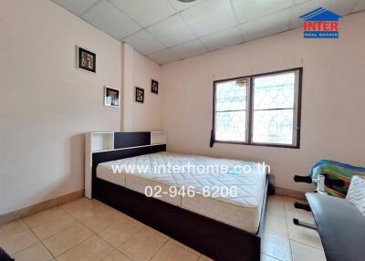 Bedroom with bed and framed pictures