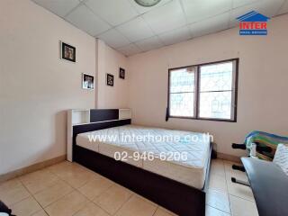 Bedroom with bed and framed pictures