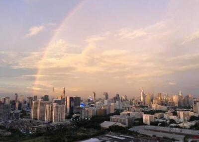 City skyline view with a rainbow