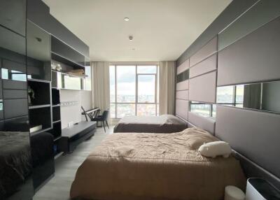 Modern bedroom with large window and double beds