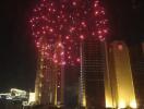 View of city skyline with fireworks at night