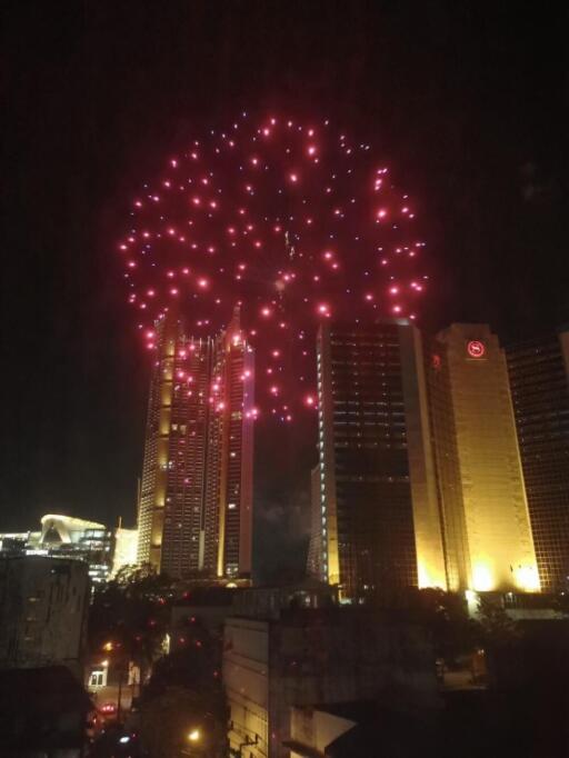 View of city skyline with fireworks at night