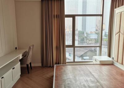 Bedroom with a large window, city views, a desk, and a chair