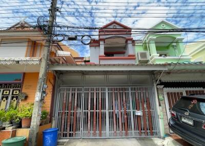 Front view of a residential building with a gated entrance