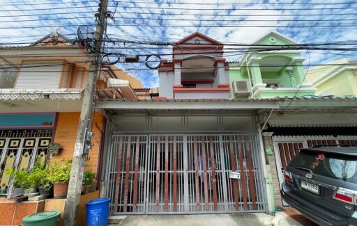 Front view of a residential building with a gated entrance