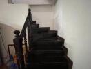 Interior staircase with black steps