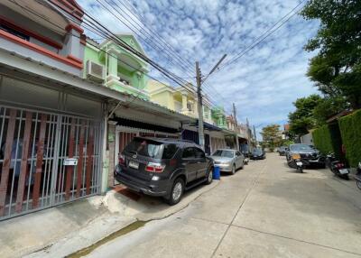 Row of colorful residential houses with parked cars