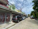 Row of colorful residential houses with parked cars