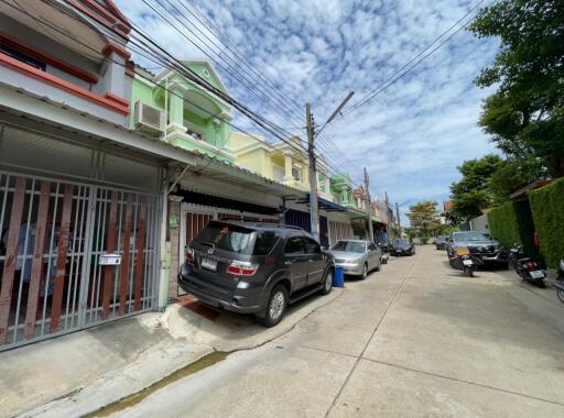 Row of colorful residential houses with parked cars