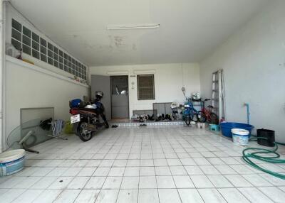 Spacious garage with tile flooring and ample storage