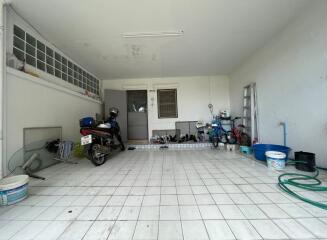 Spacious garage with tile flooring and ample storage