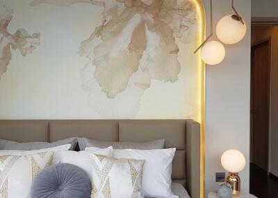 Modern bedroom with decorative lighting and wall art