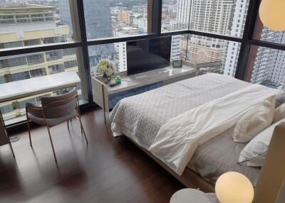 Modern bedroom with a large window and city view