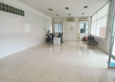 Spacious commercial area with tiled flooring and large windows