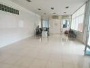 Spacious commercial area with tiled flooring and large windows