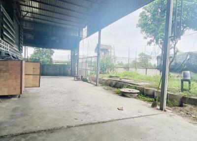 Covered outdoor industrial area with view of green landscape