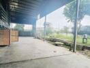 Covered outdoor industrial area with view of green landscape