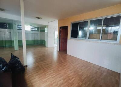 Spacious living area with wooden flooring and large windows