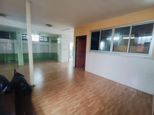 Spacious living area with wooden flooring and large windows