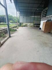 Spacious covered outdoor area with concrete flooring