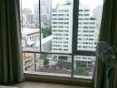 Bedroom with large window and city view