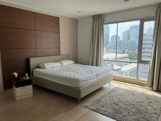 Spacious bedroom with large window and city view