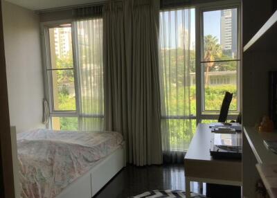 Bright bedroom with large windows and a desk