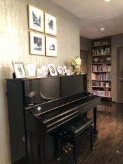 Living room with a piano and bookshelf