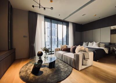 Modern bedroom with a large window, sofa, and a glass coffee table