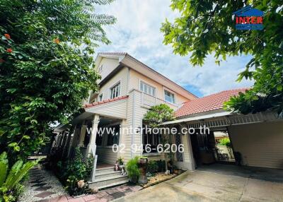 Exterior view of a residential house with lush greenery