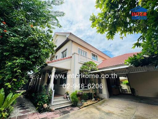 Exterior view of a residential house with lush greenery