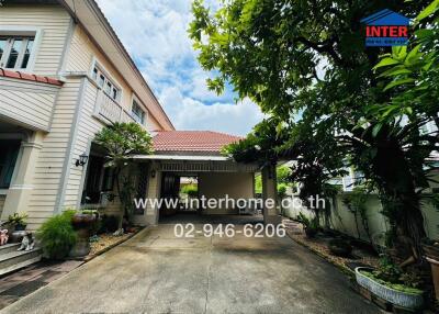 Front view of a house with a driveway and garden