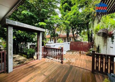 Spacious wooden deck in a lush garden setting