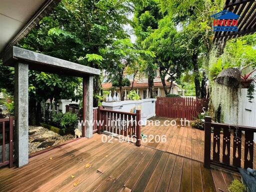 Spacious wooden deck in a lush garden setting