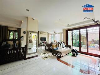 Spacious main living area with large windows and modern furnishings