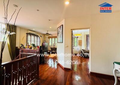 Spacious living area with wooden flooring and large windows